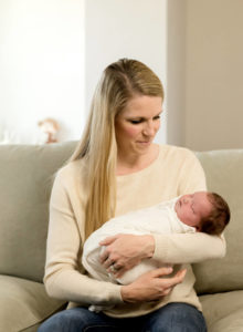 Mom holding newborn by Philadelphia Newborn Photographer